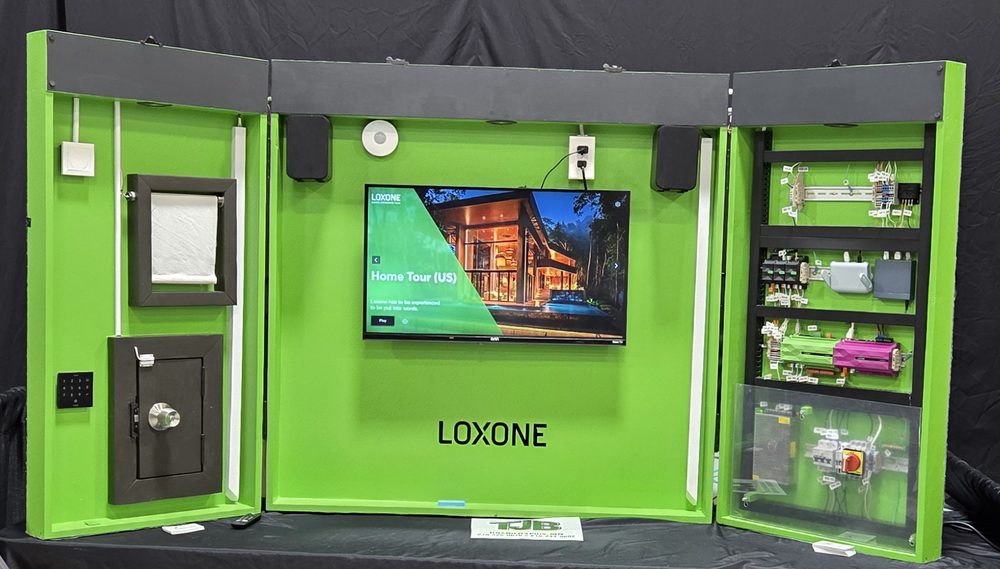 The Cornerstone demo case, open: touchscreen, speakers, motorised shade, door lock and keypad, and a live control panel section.